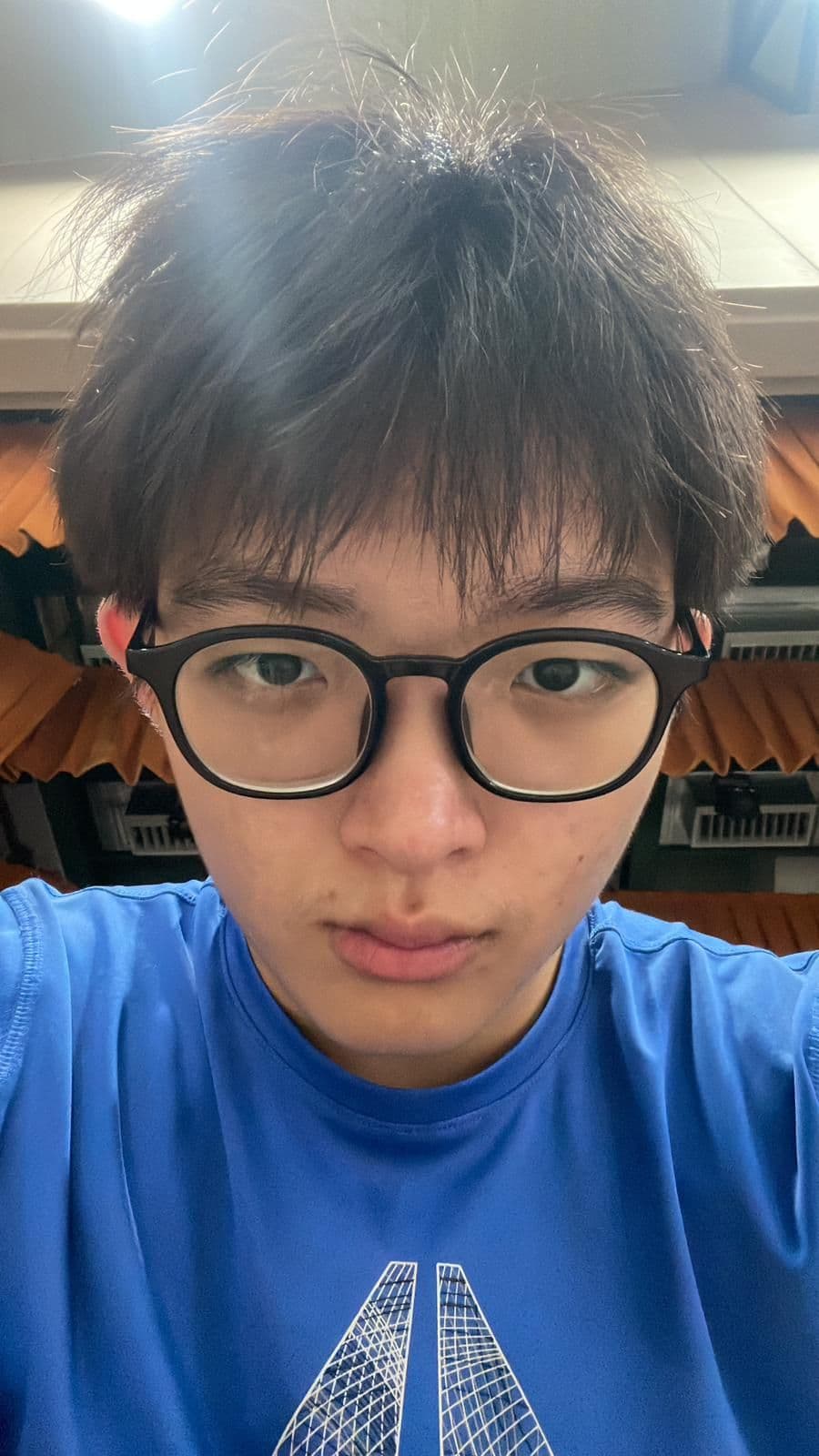 Xavier Loh in a close-up portrait wearing glasses